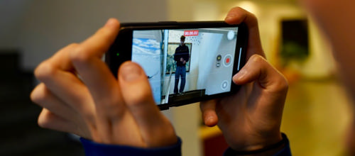 Hænder holder mobiltelefon, der optager video