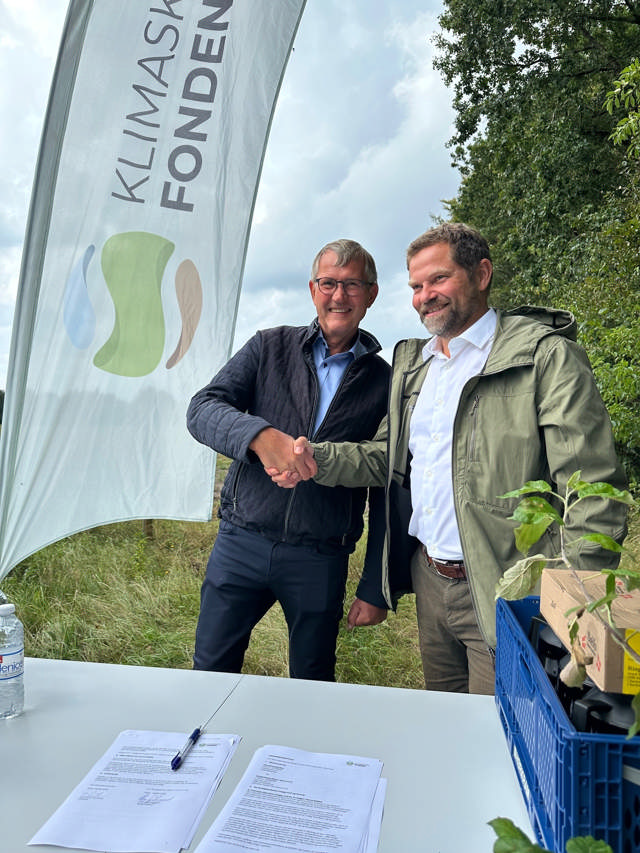 Borgmester Hans Østergaard giver hånd til Poul Erik Lauridsen, direktør i Klimaskovfonden